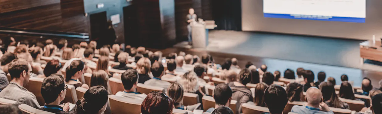 Business speaker giving a talk in conference hall