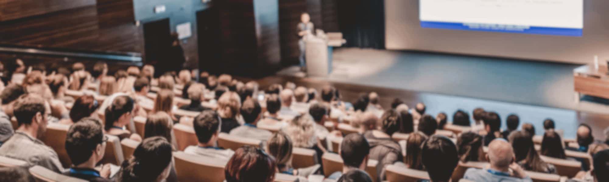 Business speaker giving a talk in conference hall